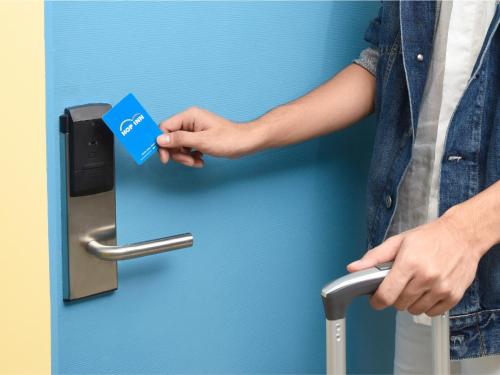 a person holding a credit card in a door handle at Hop Inn Ortigas Center Manila in Manila