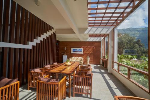 a dining room with a table and chairs on a balcony at Jiwa Jawa Resort Bromo in Bromo
