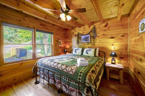 a bedroom with a bed in a log cabin at Peaks of Blue with Hot Tub and Theater Room in Sevierville