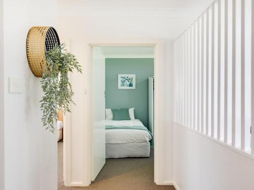 a hallway with a bedroom with a bed in it at Ocean Blue Apartment Three in Currarong