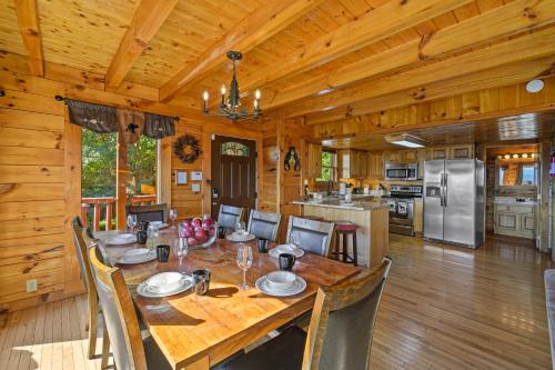 a dining room and kitchen with a table and chairs at Peaks of Blue with Hot Tub and Theater Room in Sevierville