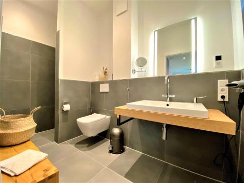 a bathroom with a sink and a toilet at Apartment Waterkamp, 26316 Dangast in Dangast