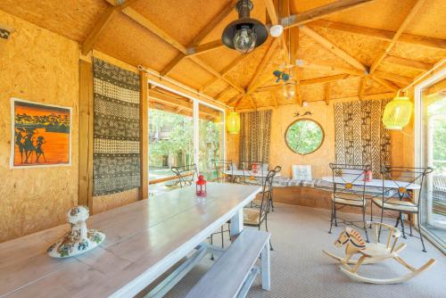 a dining room with a large wooden table and chairs at Natura Lodge in Barjac