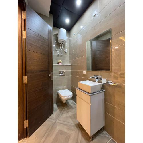 a bathroom with a toilet and a sink at Maps Inn in Ghaziabad