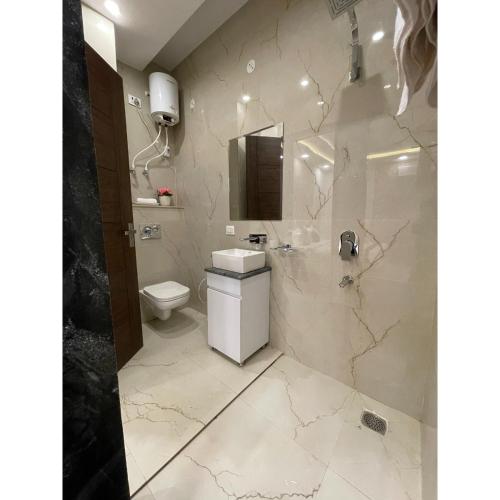 a bathroom with a toilet and a sink and a shower at Maps Inn in Ghaziabad