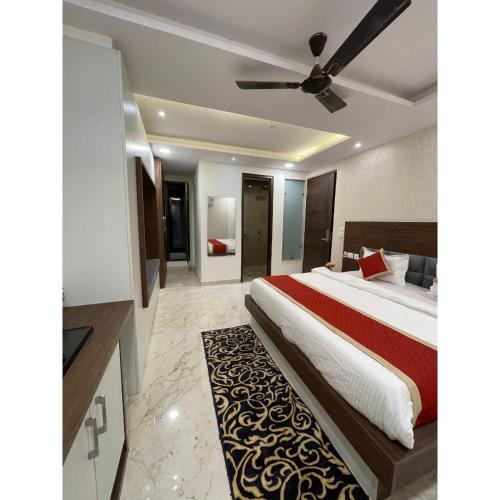 a bedroom with a bed and a ceiling fan at Maps Inn in Ghaziabad