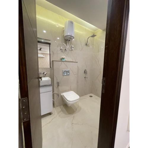 a bathroom with a toilet and a sink at Maps Inn in Ghaziabad