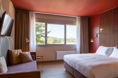 a hotel room with a large bed and a window at Conca Bella Boutique Hotel & Wine Experience in Vacallo