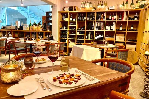a table in a restaurant with a plate of food at Conca Bella Boutique Hotel & Wine Experience in Vacallo