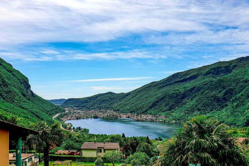 a view of a lake in a valley with mountains at Conca Bella Boutique Hotel & Wine Experience in Vacallo