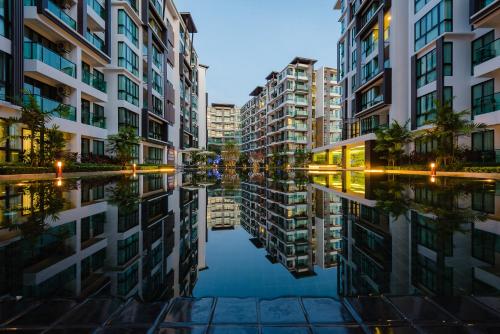 a reflection of buildings in a body of water at Wyndham Phuket Airport in Nai Yang Beach