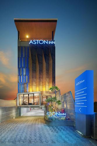 a building with a sign in front of it at Aston Inn Jemursari in Surabaya