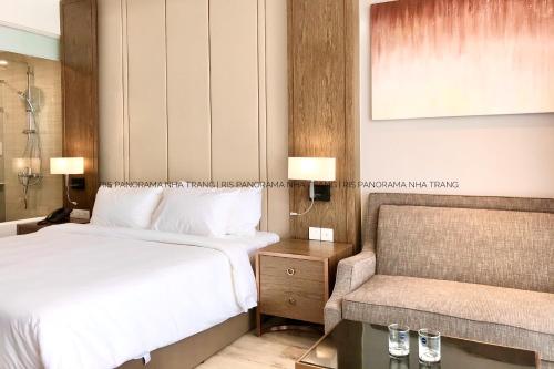 a hotel room with a bed and a chair at Panorama Nha Trang Inn in Nha Trang