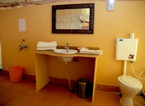 a bathroom with a sink and a toilet at Kingfisher Desert Camp in Jaisalmer