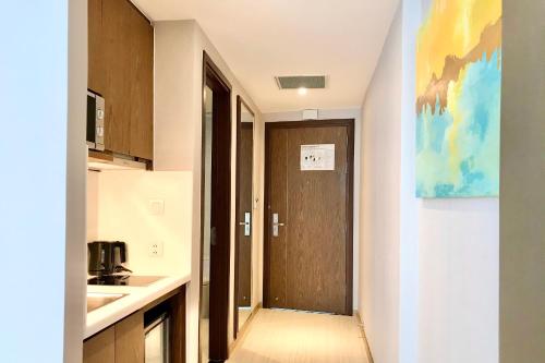 a kitchen with a brown door and a sink at Panorama Nha Trang Inn in Nha Trang