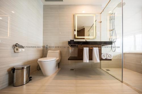 a bathroom with a toilet and a sink and a mirror at Panorama Nha Trang Inn in Nha Trang