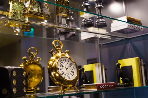 a gold clock on a shelf in a store at Leo Boutique Rooms - Adults Only in Budapest