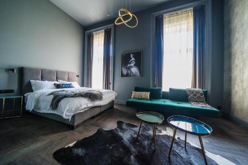 a bedroom with a bed and a couch at Leo Boutique Rooms - Adults Only in Budapest