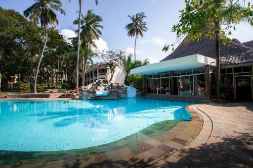 a swimming pool in front of a resort at Severin Sea Lodge in Mombasa