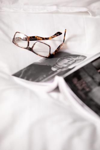 a pair of glasses sitting on top of a newspaper at N - SPACE modern guestrooms in Rome