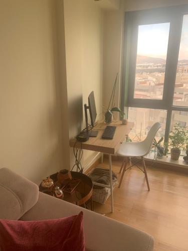 a room with a desk with a computer and a chair at Ático El Reducto views in Arrecife