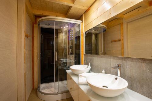 a bathroom with two sinks and a glass shower at DalaiLama Village in Antey-Saint-André