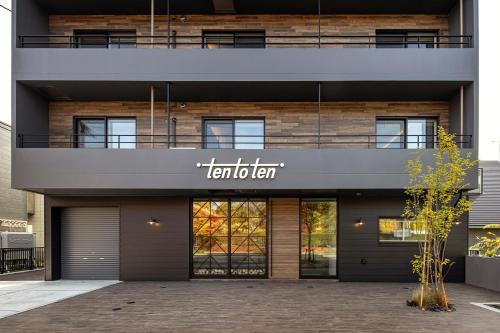 a building with a sign on the side of it at Hotel Ten to Ten in Sapporo