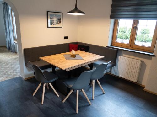 a dining room with a wooden table and chairs at LUSE Living in Maurach