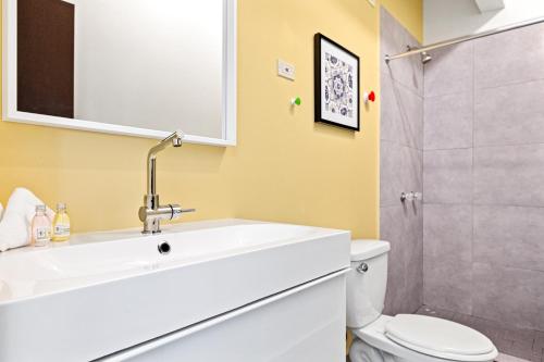 a bathroom with a sink and a toilet and a shower at Rincon Plaza Hotel in Rincon