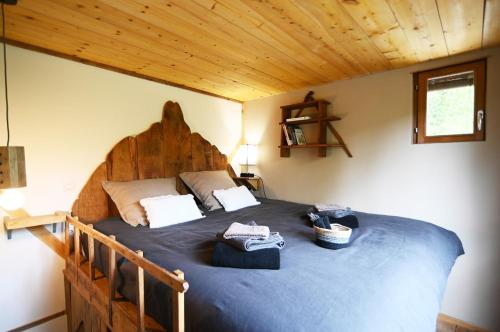 a bedroom with a large bed in a cabin at La Cabane in Connigis