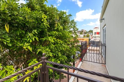 a balcony with a fence and trees at Rincon Plaza Hotel in Rincon