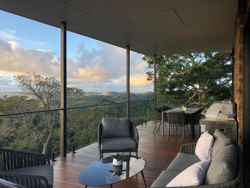 a living room with a couch and chairs on a balcony at The Ridge at Maleny 3 Bedroom Executive Residence in Maleny