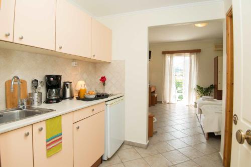 a kitchen with a sink and a counter top at Spira Studios & Apartments in the Heart of Laganas in Laganas
