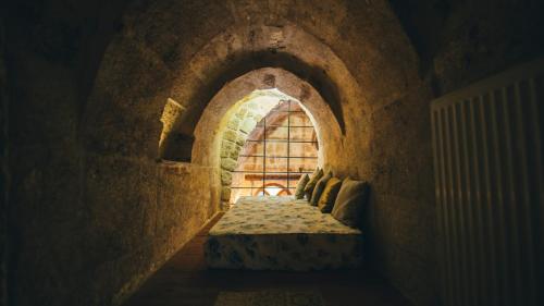 a room with an archway with a window at Cappadocia Old Houses in Nevsehir