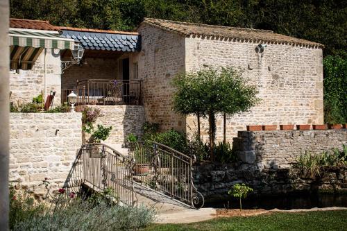 a brick building with a staircase in a garden at chambre d'hôtes le moulin d'âne niort in Niort