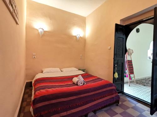 Un dormitorio con una cama con una toalla. en Dar Mirai, en Marrakech