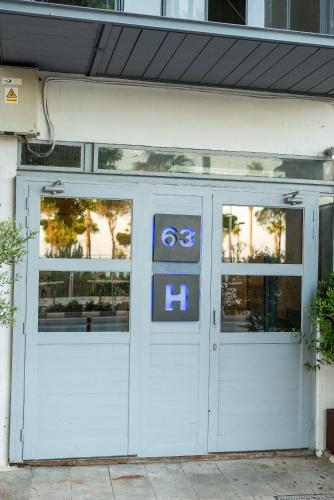 a white garage door with signs on it at City Centre Rooms in Limassol