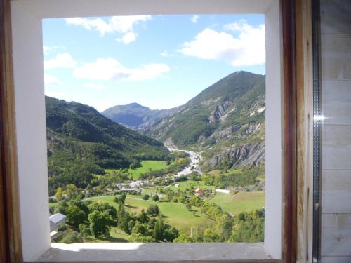 a view from a window of a valley at La Miellerie des Nuages in Prads-Haute-Bléone