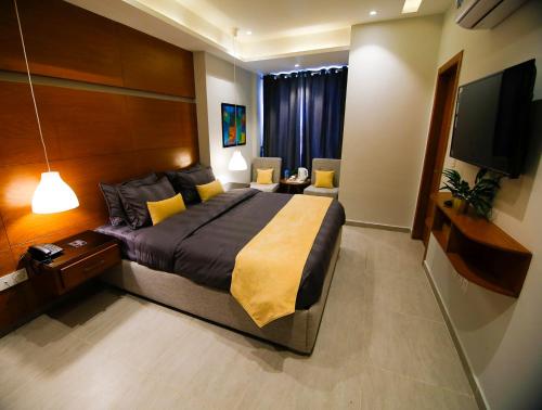 a bedroom with a large bed and a flat screen tv at Space Express in Rawalpindi