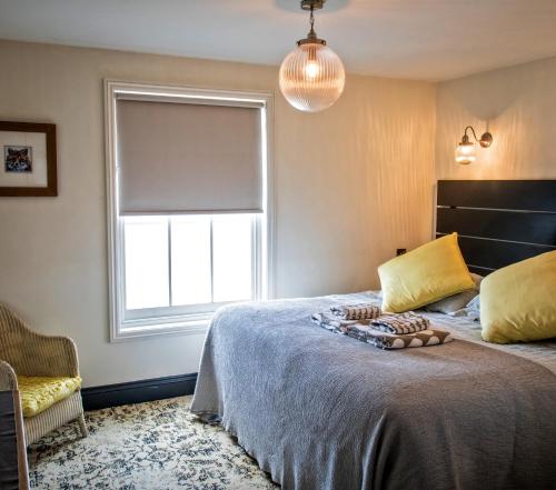 a bedroom with a large bed and a large window at The Poplars Boutique BB in Lincoln