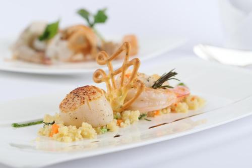 a plate of food with shrimp and vegetables on a table at Landhotel Hirsch in Tübingen