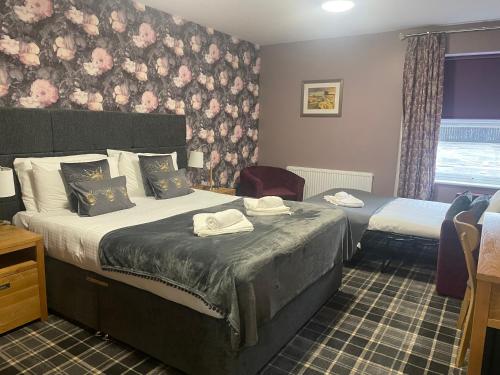 a hotel room with two beds and a window at The Portland in Ashington