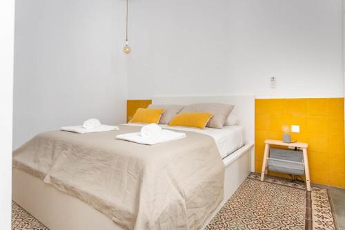 a bedroom with a bed with two towels on it at Pop Art , Sunny Apartment near Santa Cruz in Seville