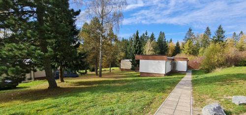 a path in a park with trees and a building at HOTEL SVRATKA in Svratka