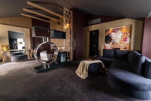 a living room with a blue couch and a mirror at Atik Hotel in Unye