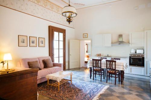 a living room with a couch and a table at Villa Guarienti Valpolicella in Fumane