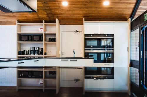 a kitchen with white cabinets and a counter top at Gîte de la Tour - Dinant Evasion in Dinant