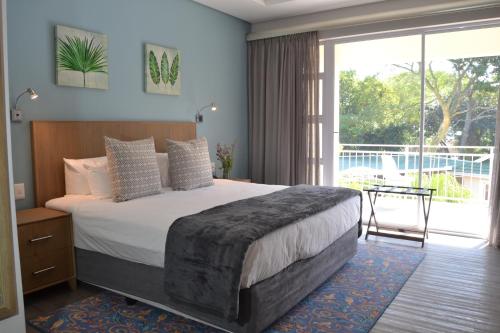 Tempat tidur dalam kamar di Golf Course Boutique Guesthouse