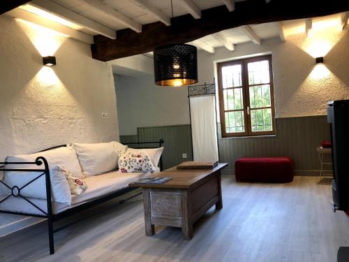 a living room with a couch and a coffee table at Havre de paix et de verdure proche Walibi et A43 - 4 étoiles in Corbelin