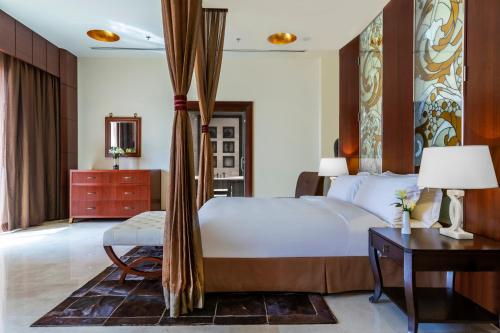 a bedroom with a bed and a table and a desk at Crowne Plaza Al Khobar, an IHG Hotel in Al Khobar